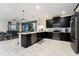 Open concept kitchen with island and dark cabinetry at 8896 Cabot Cliffs Dr, Davenport, FL 33896