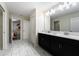 Clean bathroom with double vanity and marble-look tile at 8896 Cabot Cliffs Dr, Davenport, FL 33896