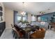 Open concept dining room with a spacious table and access to the living room at 8896 Cabot Cliffs Dr, Davenport, FL 33896