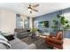 Bright living room with comfy sofas, large TV, and stylish decor at 8896 Cabot Cliffs Dr, Davenport, FL 33896