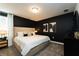 Stylish bedroom with a king-size bed and dark-colored walls at 8896 Cabot Cliffs Dr, Davenport, FL 33896
