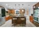 Modern kitchen with island, stainless steel appliances, and granite countertops at 2579 Creekview Cir, Oviedo, FL 32765