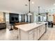 Modern kitchen with a large island, white cabinets, and stainless steel appliances at 1861 Sawyer Palm Pl, Kissimmee, FL 34747