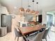 Dining room with rustic wood table and modern copper pendant lights at 1861 Sawyer Palm Pl, Kissimmee, FL 34747
