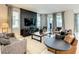 Living room with a dark wood accent wall, large TV, and comfortable seating at 1861 Sawyer Palm Pl, Kissimmee, FL 34747