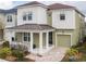 Two-story house with a green exterior, brown roof, and a porch at 1861 Sawyer Palm Pl, Kissimmee, FL 34747