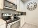 Well-equipped kitchen with stainless steel appliances and gray backsplash at 1861 Sawyer Palm Pl, Kissimmee, FL 34747