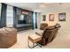Home theater with large TV, comfortable seating, and movie posters at 1861 Sawyer Palm Pl, Kissimmee, FL 34747