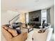 Spacious living room with leather sofas, a large TV, and a wooden coffee table at 1861 Sawyer Palm Pl, Kissimmee, FL 34747
