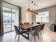 Dining room with pool view and modern pendant lighting at 1861 Sawyer Palm Pl, Kissimmee, FL 34747