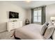 King bedroom with TV, dresser and window at 1861 Sawyer Palm Pl, Kissimmee, FL 34747