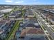 Aerial view of community with lake and numerous houses at 1861 Sawyer Palm Pl, Kissimmee, FL 34747