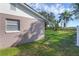 Home's side yard with green grass and trees at 2319 Continental Blvd, Orlando, FL 32808