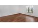 Spacious bedroom with wood-look floors and large window at 2319 Continental Blvd, Orlando, FL 32808