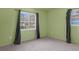 Spacious bedroom with two windows and grey curtains at 2319 Continental Blvd, Orlando, FL 32808