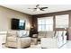 Spacious living room with comfortable seating and large TV at 4535 Narrative Ln, Kissimmee, FL 34746
