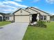 One-story home with attached garage and well-maintained landscaping at 4394 Sagefield Dr, Harmony, FL 34773