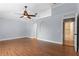 Main bedroom with hardwood floors, ceiling fan, and access to en-suite bathroom at 2978 Ruxton Dr, Apopka, FL 32712