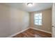 Simple bedroom with hardwood floor and a window at 1506 W 16Th St, Sanford, FL 32771