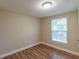 Bright bedroom featuring wood-look floors and a window with blinds at 1506 W 16Th St, Sanford, FL 32771