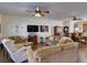 Spacious living area with hardwood floors, comfortable seating, and a TV at 535 Crimson Ln, Winter Springs, FL 32708