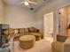 Cozy Gathering room featuring a sectional sofa, ottoman, and large TV at 535 Crimson Ln, Winter Springs, FL 32708