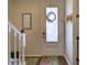 Bright entryway with wood floors, decorative mirror, and frosted glass door at 535 Crimson Ln, Winter Springs, FL 32708