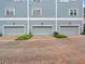 Three attached garages with brick driveway and landscaping at 535 Crimson Ln, Winter Springs, FL 32708