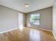 Spacious bedroom featuring hardwood floors and a large window at 810 S Galena Ave, Minneola, FL 34715