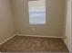 Simple bedroom with neutral walls and carpet flooring at 512 W Ella J Gilmore St, Apopka, FL 32703
