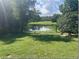Large backyard with pond view, offering a tranquil setting at 512 W Ella J Gilmore St, Apopka, FL 32703