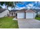 Two-car garage and pink exterior at 5418 S Bracken Ct, Winter Park, FL 32792