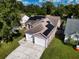 Home's aerial view showcases solar panels and yard at 5418 S Bracken Ct, Winter Park, FL 32792