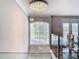 Elegant interior with a grand chandelier and large windows offering abundant natural light at 10542 Wittenberg Way, Orlando, FL 32832