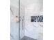 Modern shower with marble tile and glass enclosure at 10542 Wittenberg Way, Orlando, FL 32832