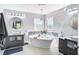 Luxurious bathroom featuring a freestanding tub and dual vanities at 10542 Wittenberg Way, Orlando, FL 32832