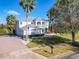 Two-story house with large front yard and palm trees at 10542 Wittenberg Way, Orlando, FL 32832