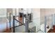 Modern glass and metal staircase with hardwood floors at 10542 Wittenberg Way, Orlando, FL 32832