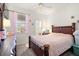 Charming bedroom with a wooden bed frame and en-suite bathroom at 348 Sand Ridge Dr, Davenport, FL 33896