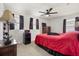 Bedroom with red bedding and a ceiling fan at 348 Sand Ridge Dr, Davenport, FL 33896