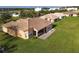 Aerial view of single story house with tile roof and screened lanai at 3623 Weatherfield Dr, Kissimmee, FL 34746