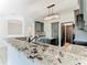 Granite countertop kitchen with gray cabinets and a breakfast bar at 3623 Weatherfield Dr, Kissimmee, FL 34746