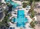 Aerial view of resort-style pool with multiple areas for swimming and lounging at 3623 Weatherfield Dr, Kissimmee, FL 34746
