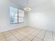 Bright dining room with tile flooring and a modern light fixture at 3623 Weatherfield Dr, Kissimmee, FL 34746