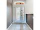 Elegant entryway with a white door, glass inserts, and tile flooring at 3623 Weatherfield Dr, Kissimmee, FL 34746
