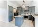 Modern kitchen with gray cabinets, granite countertops, and stainless steel appliances at 3623 Weatherfield Dr, Kissimmee, FL 34746
