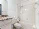 Simple bathroom with shower/tub, granite countertop, and white cabinets at 3623 Weatherfield Dr, Kissimmee, FL 34746