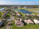 Aerial view of community with lake and homes at 3623 Weatherfield Dr, Kissimmee, FL 34746
