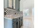Gray cabinets and granite countertop with patterned backsplash in kitchen at 3623 Weatherfield Dr, Kissimmee, FL 34746