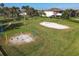 Recreation area featuring swings, a volleyball court, and a grassy field at 3623 Weatherfield Dr, Kissimmee, FL 34746